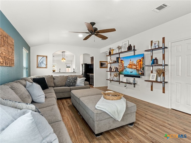 2416 Kolton St, New Braunfels, TX 78130 - living area with arched walkways, ceiling fan, wood finished floors, and vaulted ceiling