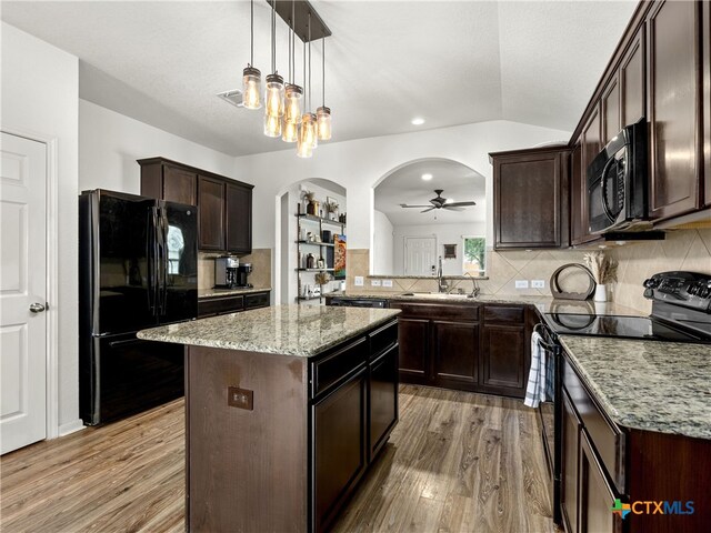 2416 Kolton St, New Braunfels, TX 78130 - kitchen featuring black appliances, light wood-style floors, ceiling fan, dark brown cabinetry, and vaulted ceiling