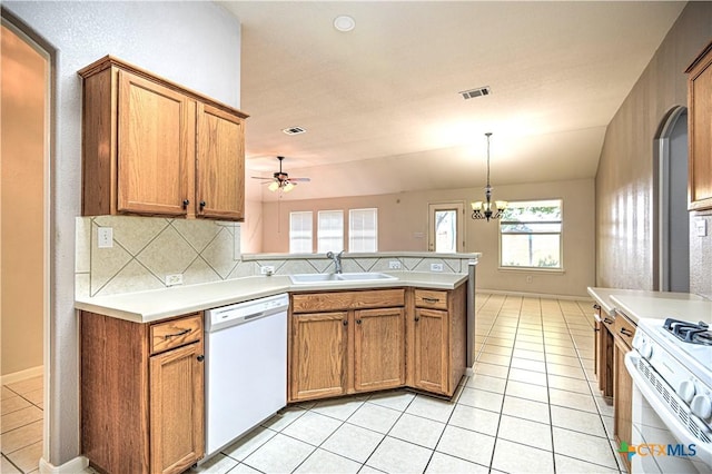 1900 Rutherford Dr, Leander, TX 78641 - kitchen featuring white appliances, a peninsula, a ceiling fan, and light countertops