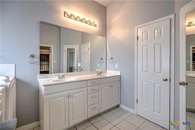 1900 Rutherford Dr, Leander, TX 78641 - bathroom with double vanity and tile patterned floors
