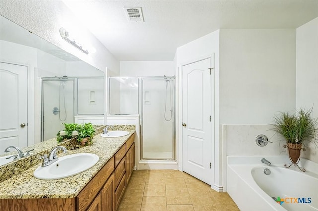 bathroom featuring vanity, tile patterned floors, and separate shower and tub