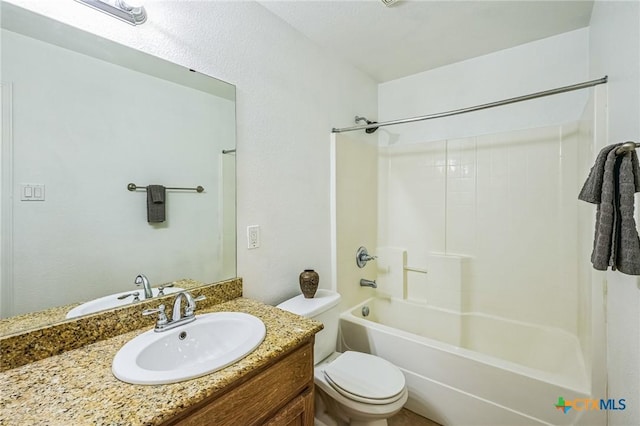 full bathroom with shower / tub combination, vanity, and toilet