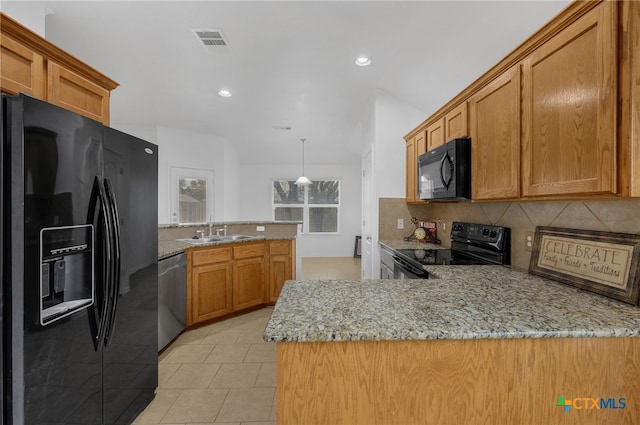 kitchen featuring sink, black appliances, light tile patterned flooring, decorative backsplash, and kitchen peninsula