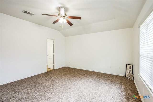 carpeted spare room with lofted ceiling and ceiling fan