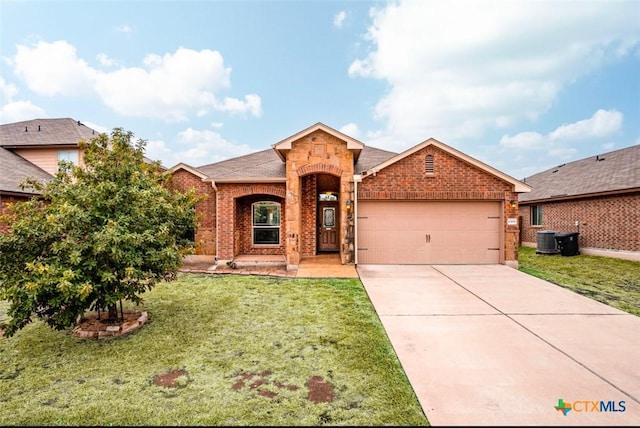 view of front of house featuring cooling unit, a garage, and a front lawn