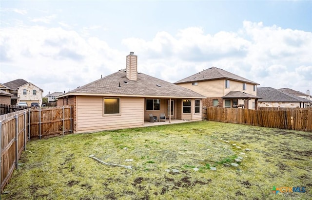 back of property featuring a yard and a patio