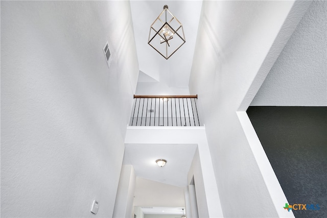 staircase featuring a high ceiling