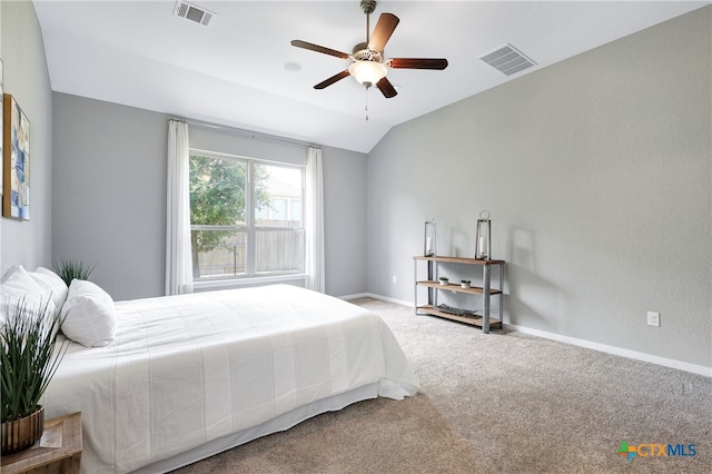 carpeted bedroom with ceiling fan and vaulted ceiling