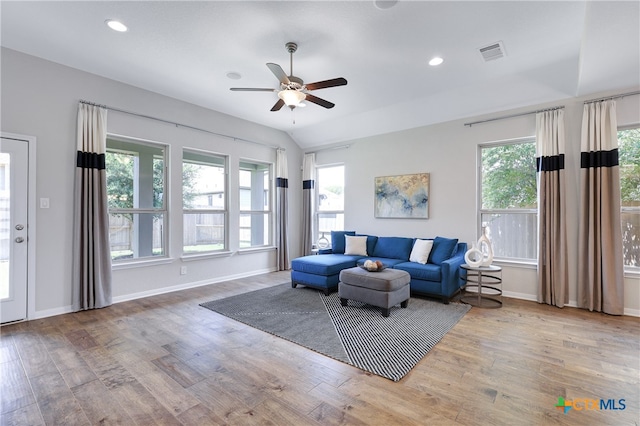 living room featuring lofted ceiling, wood-type flooring, and ceiling fan