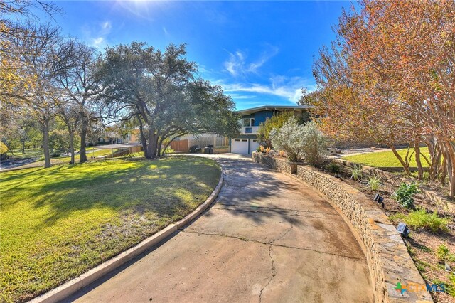 view of front of house featuring a front yard and a garage