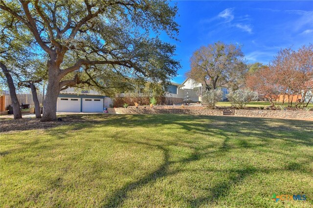 view of yard featuring an outbuilding and a garage