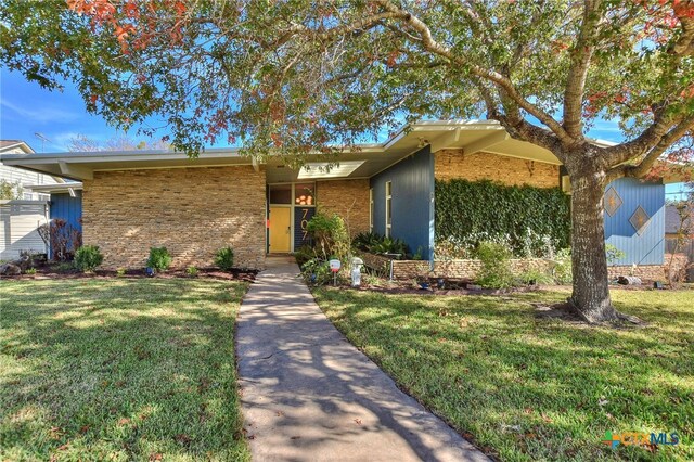 ranch-style home with a front lawn