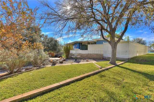 view of side of property with a yard