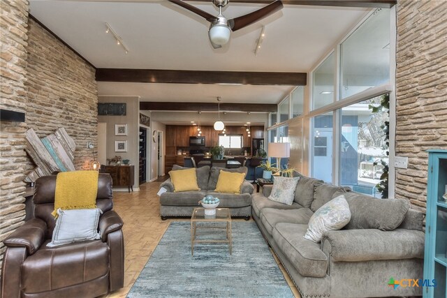 living room with ceiling fan and beam ceiling