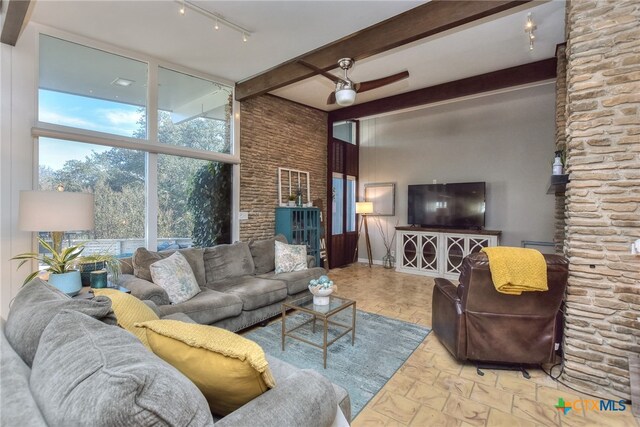 living room with beamed ceiling, ceiling fan, and rail lighting