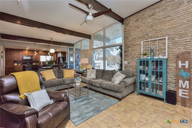 living room featuring ceiling fan and beamed ceiling