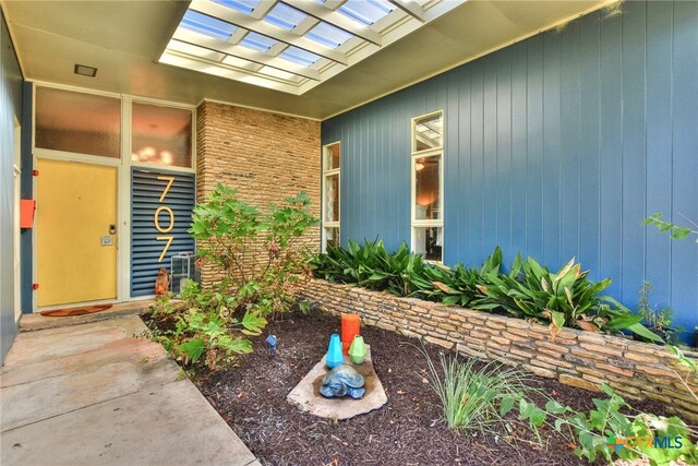 property entrance with a pergola