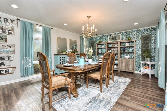 dining space featuring dark hardwood / wood-style floors, crown molding, and a notable chandelier