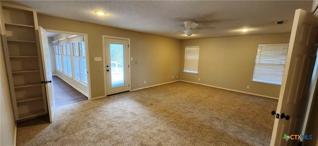 217 Taylors Dr, Temple, TX 76502 - entryway featuring dark colored carpet, a ceiling fan, baseboards, and a textured ceiling