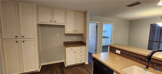 217 Taylors Dr, Temple, TX 76502 - kitchen with a sink, dark wood finished floors, dishwasher, a textured ceiling, and baseboards