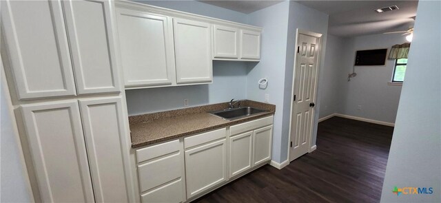 217 Taylors Dr, Temple, TX 76502 - kitchen featuring a sink, dark wood-style floors, baseboards, and white cabinets