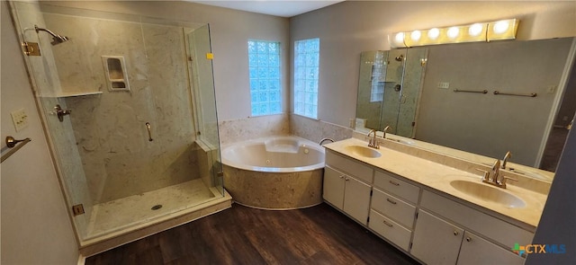 217 Taylors Dr, Temple, TX 76502 - bathroom featuring a stall shower, wood finished floors, a garden tub, and double vanity
