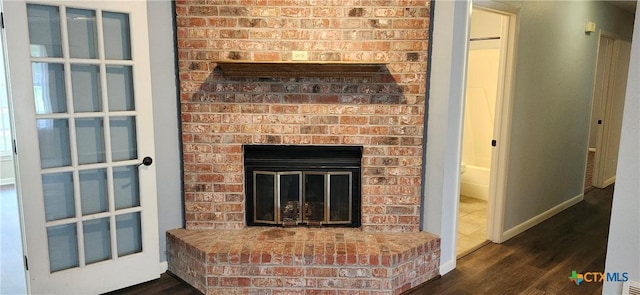 217 Taylors Dr, Temple, TX 76502 - detailed view of wood finished floors, a brick fireplace, and baseboards