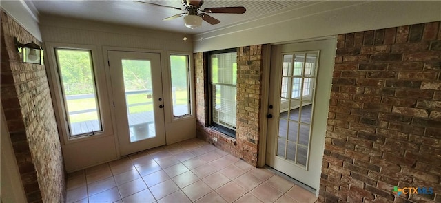 217 Taylors Dr, Temple, TX 76502 - entryway featuring light tile patterned floors, healthy amount of natural light, ceiling fan, and brick wall