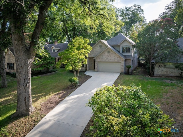 view of front of property with a front lawn and a garage