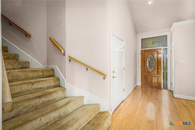 entryway featuring wood-type flooring and lofted ceiling