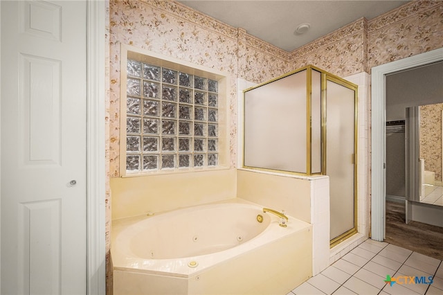 bathroom with tile patterned floors and independent shower and bath