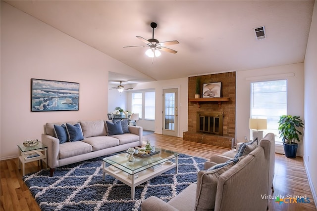 living room featuring lofted ceiling, hardwood / wood-style floors, and plenty of natural light