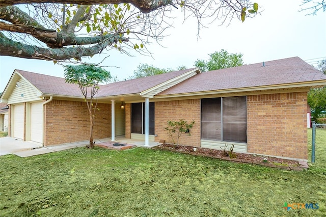 single story home featuring a front lawn and a garage