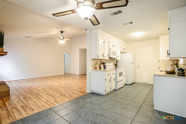 kitchen with white cabinetry, ceiling fan, white appliances, light hardwood / wood-style flooring, and vaulted ceiling