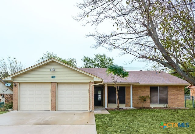 single story home featuring a garage and a front yard