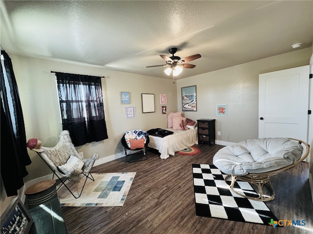bedroom with ceiling fan, baseboards, a textured ceiling, and wood finished floors