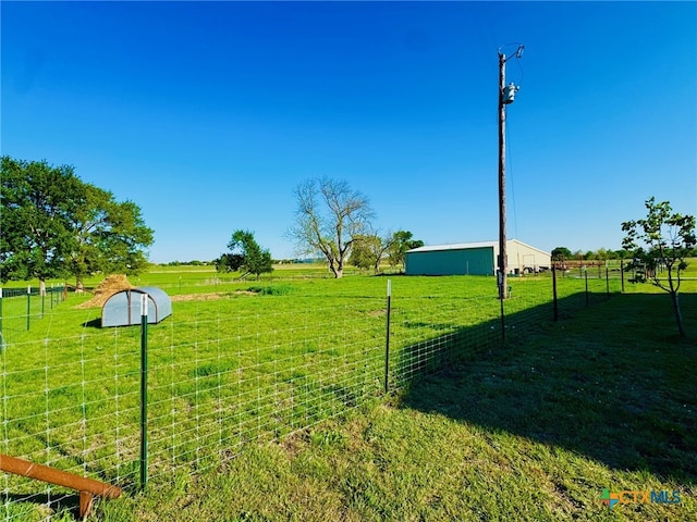 view of yard with a rural view and fence