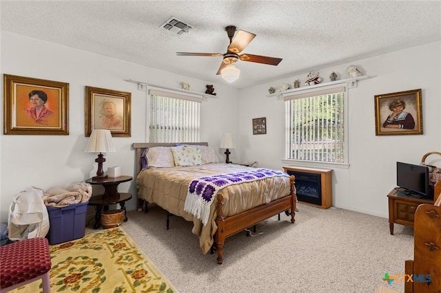 134 Daisy Ln, Whitney, TX 76692 - carpeted bedroom featuring a textured ceiling and ceiling fan