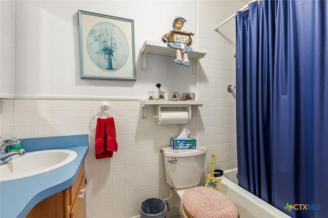 134 Daisy Ln, Whitney, TX 76692 - bathroom with tile walls, vanity, shower / tub combo, and toilet