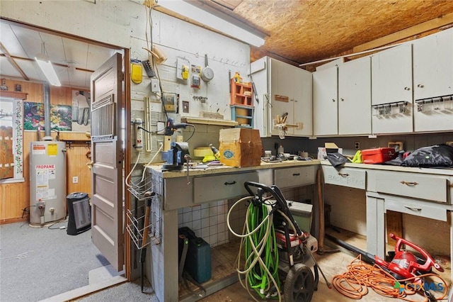 134 Daisy Ln, Whitney, TX 76692 - miscellaneous room with water heater and a workshop area