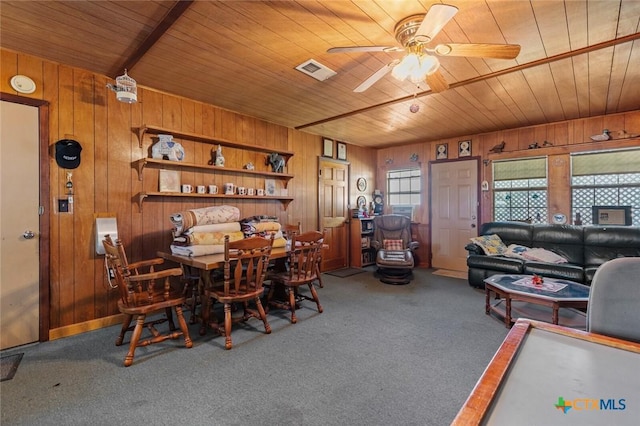134 Daisy Ln, Whitney, TX 76692 - carpeted dining room featuring wood ceiling, wood walls, and ceiling fan