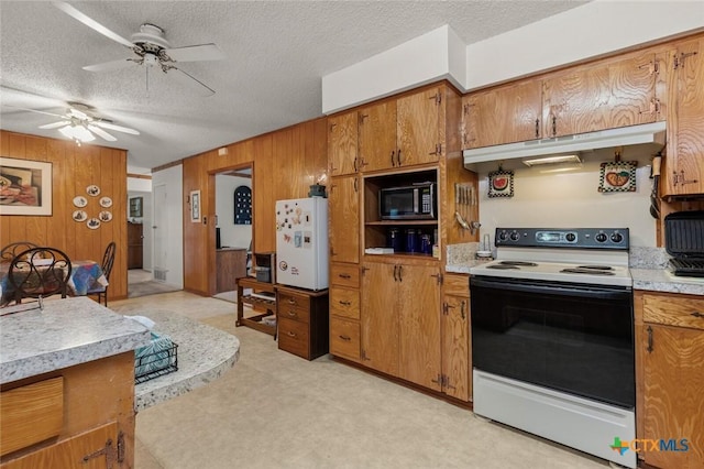 134 Daisy Ln, Whitney, TX 76692 - kitchen featuring electric range oven, freestanding refrigerator, brown cabinets, under cabinet range hood, and light countertops