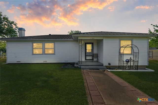134 Daisy Ln, Whitney, TX 76692 - view of front facade with a yard, a chimney, and metal roof