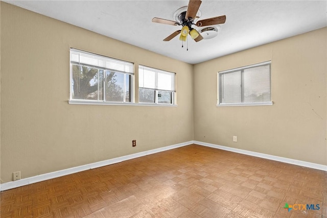 spare room featuring ceiling fan and light parquet flooring