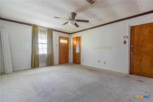 carpeted spare room featuring ceiling fan, a textured ceiling, and ornamental molding