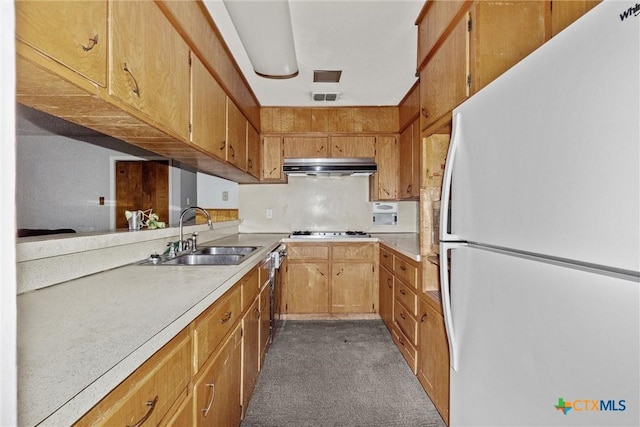 kitchen with dark carpet, gas cooktop, dishwasher, white refrigerator, and sink