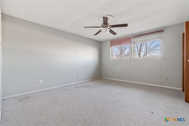 spare room featuring ceiling fan and light carpet