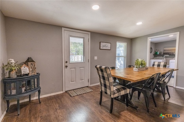 dining area with dark hardwood / wood-style flooring and washer and dryer