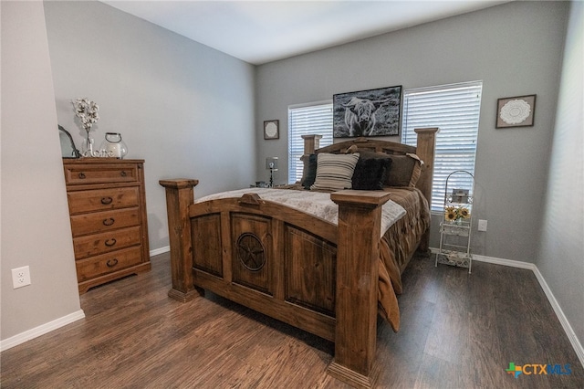 bedroom with dark hardwood / wood-style flooring