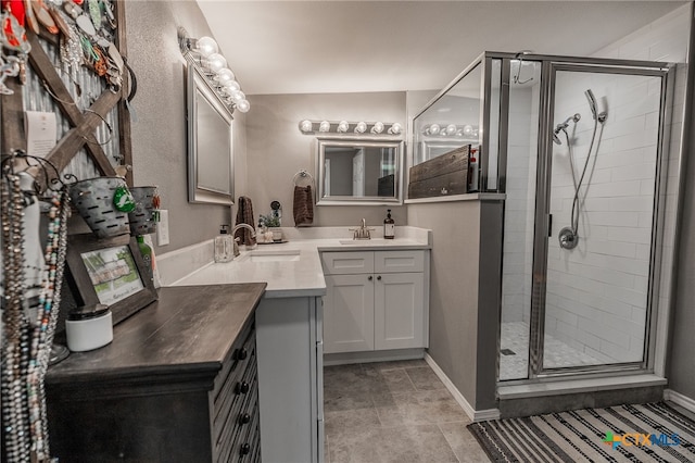 bathroom featuring tile patterned flooring, vanity, and a shower with door